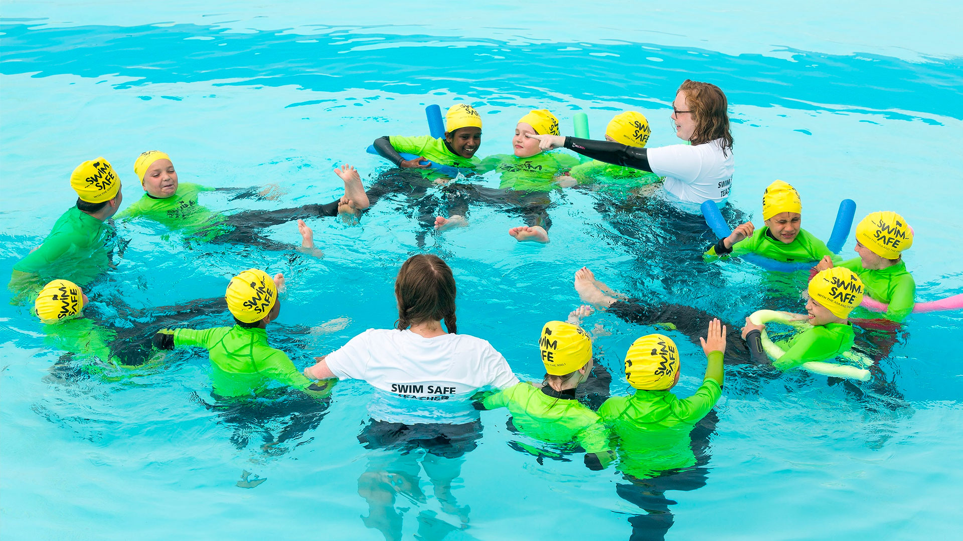 Teacher with a group of children swimming