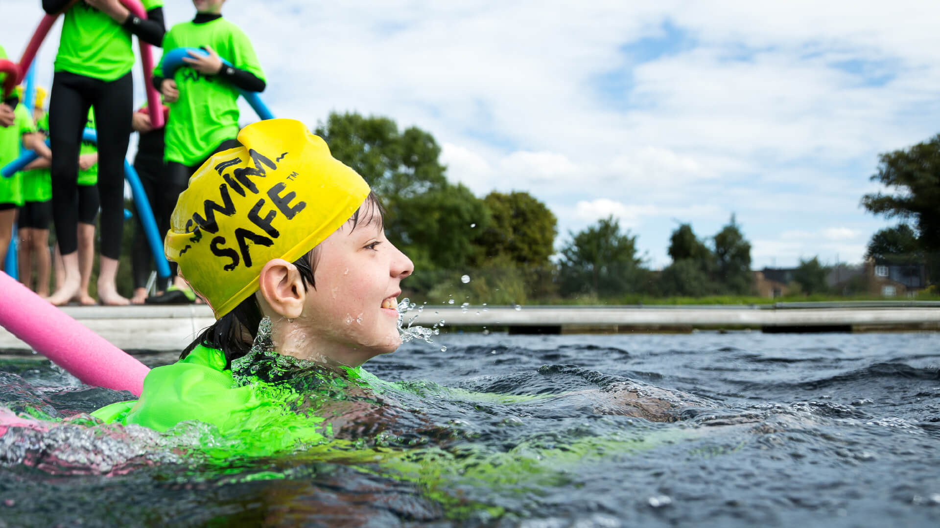 A young boy jumps swimming in the water at West Reservoir, Stoke Newington in London.